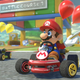 Mario races against Yoshi in Mario Kart 8's battle mode while holding a feather.